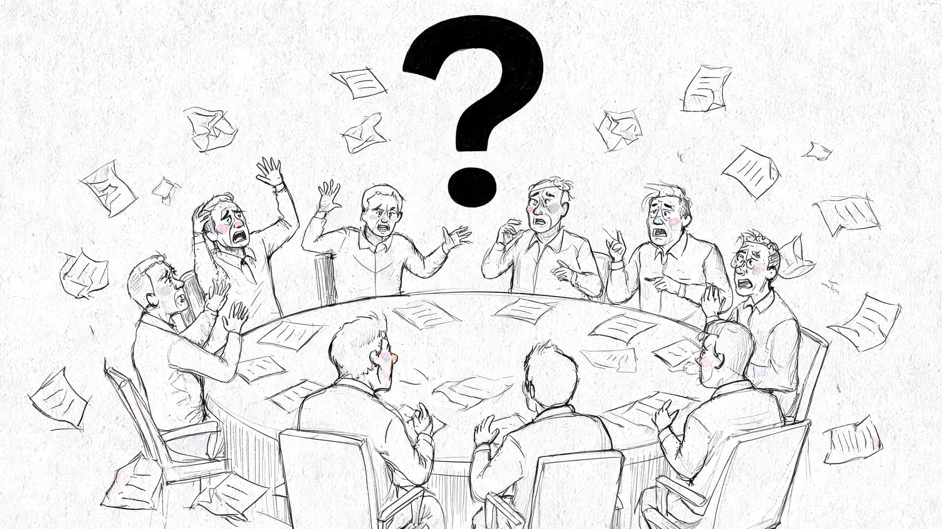 A group of stressed business people sitting around a round table filled with flying documents