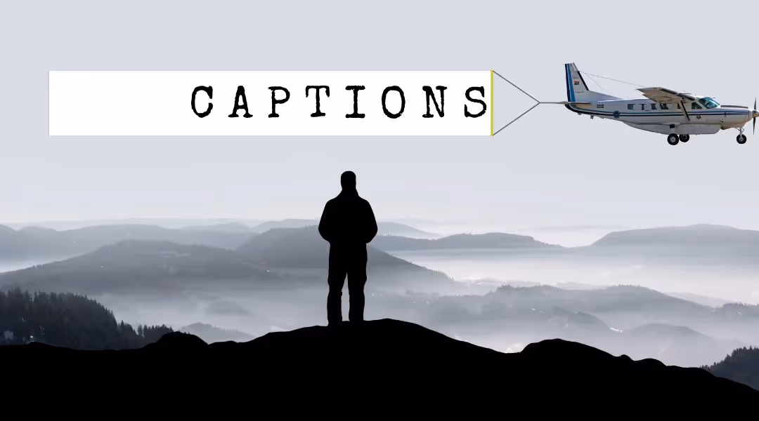 Silhouetted figure on a hilltop watching a plane tow a banner reading 'CAPTIONS' over misty hills