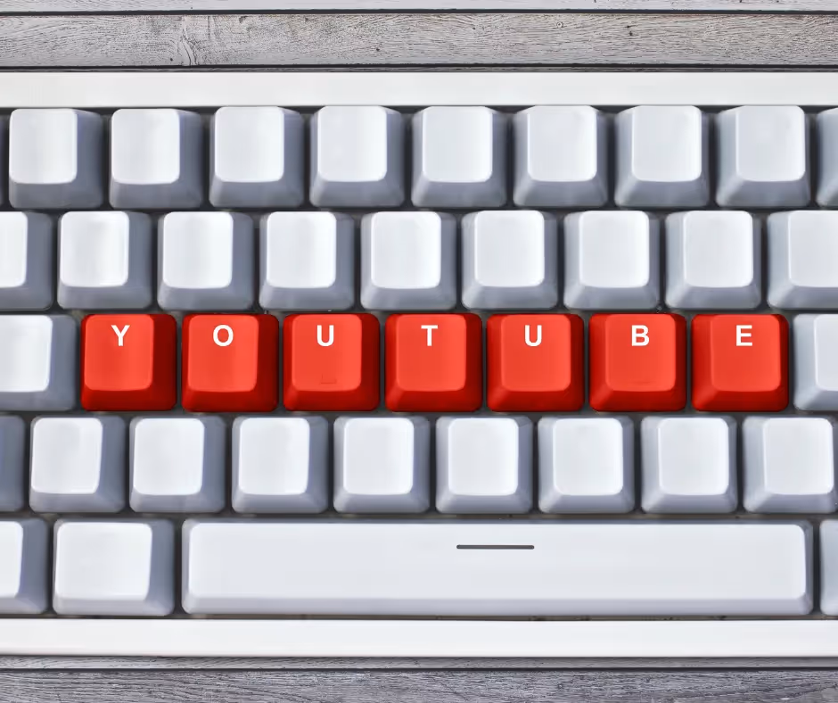 A white keyboard whose middle row of red keys spells YOUTUBE