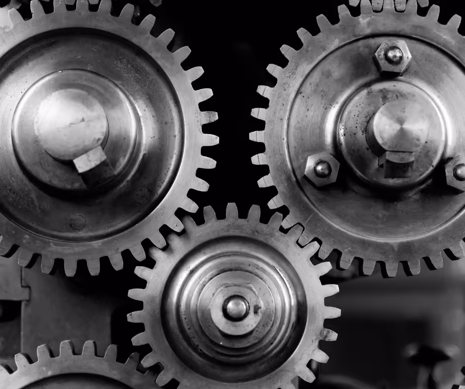 Close-up black-and-white photo of three interlocking metal gears